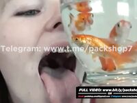 Beautiful white woman devours her fish alive - vore